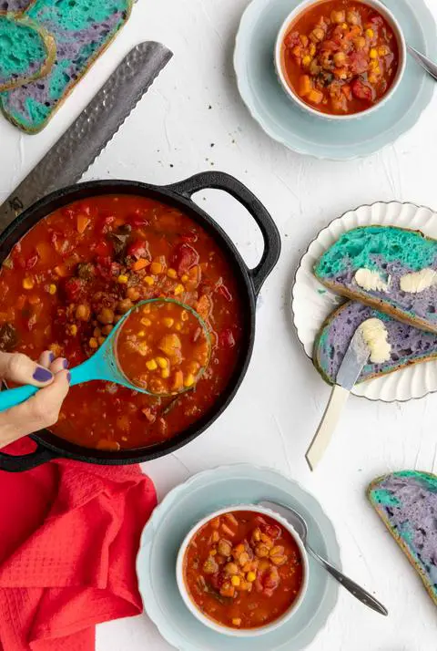 ladling veggie soup into bowls