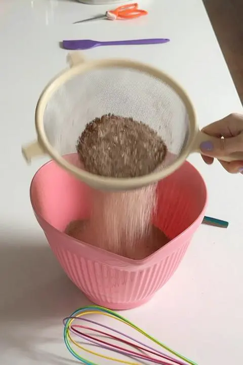 Sifting the dry ingredients for the cake batter.