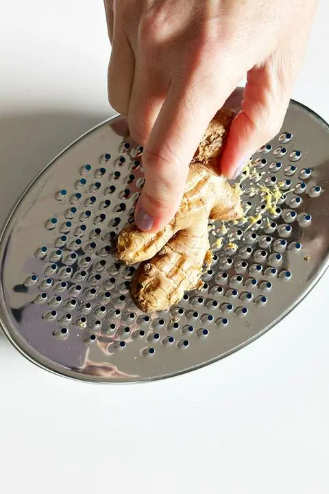 grating ginger for the carrot celery miso ginger soup.