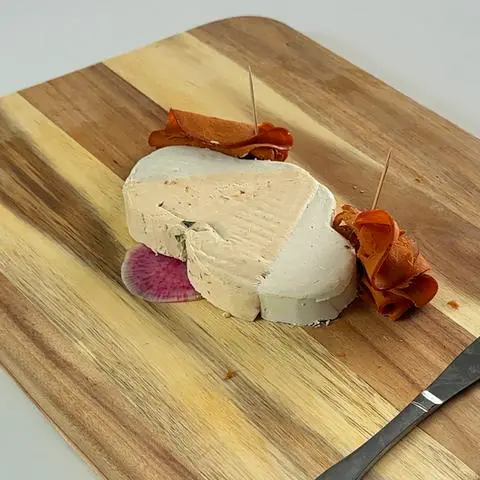 the vegan cheese dog with vegan meat ears and a watermelon radish tongue..