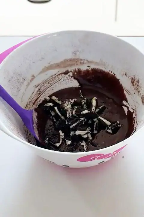 adding the vegan chocolate sandwich cookies to the brownie batter.