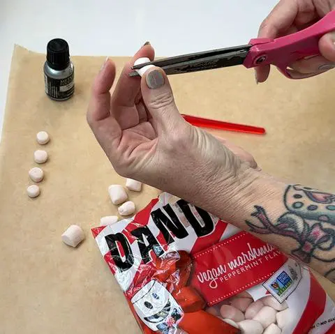 cutting mini vegan marshmallows in half.