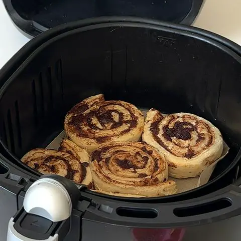 air fryer cinnamon rolls after cooking for 4 minutes.