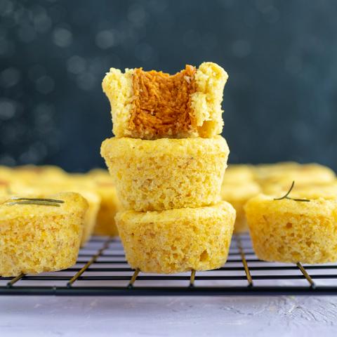 mini vegan corn dog nuggets, with a bite missing from one