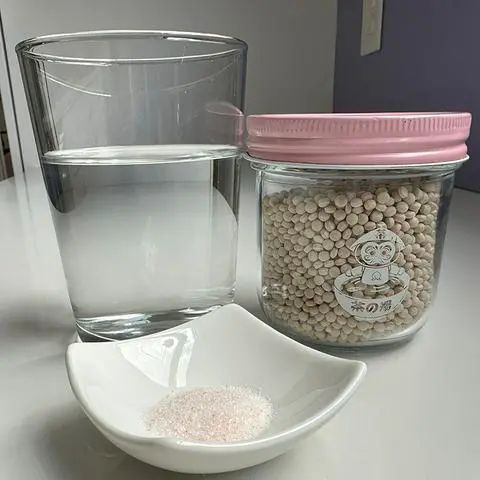 water, salt, and pearl couscous in a jar.