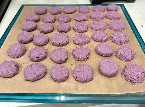 a dehydrator tray of purple sweet potato treats.