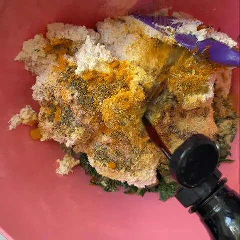 adding Braggs liquid aminos to the bowl.