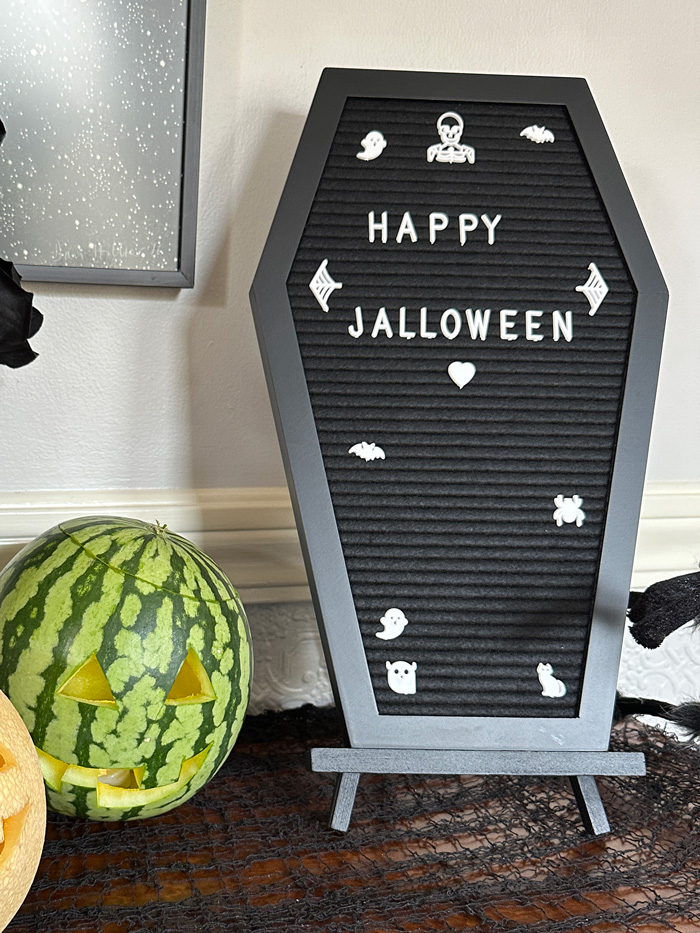coffin message board with the message Happy Jalloween.