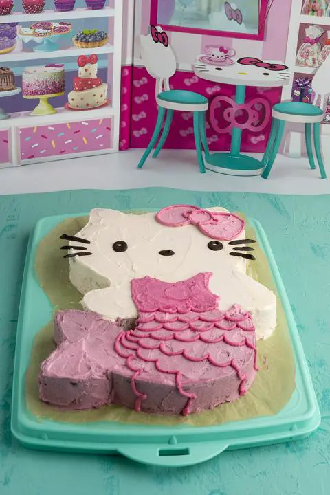 pink and purple Hello Kitty cake with a Hello Kitty cafe background.