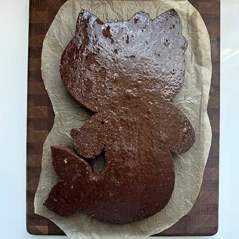 the hello kitty chocolate cake on trimmed parchment paper.