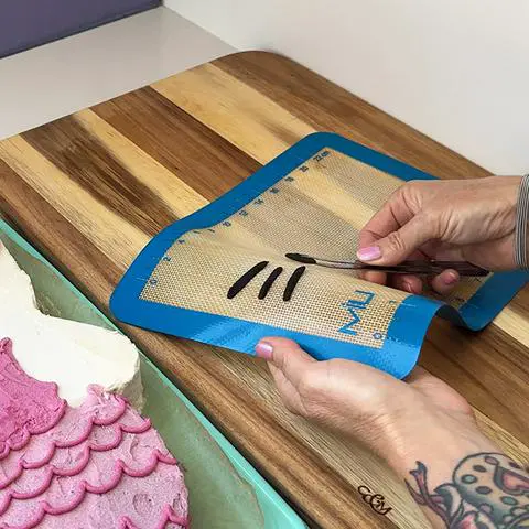 removing a chocolate eye from a silicone mat.