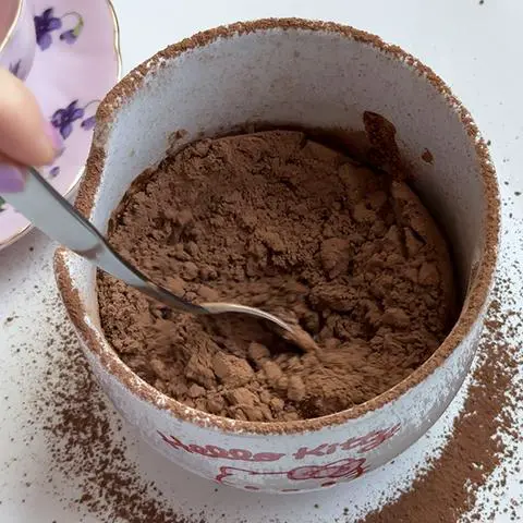 starting to stir the coffee and cocoa powder.