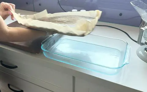moving the cake from the cake pan to a cutting board.