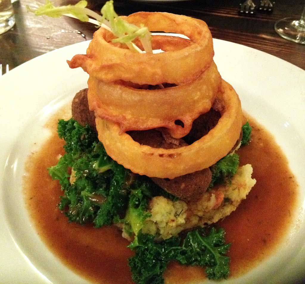 bangers and mash topped with onion rings from Manna in London, England.