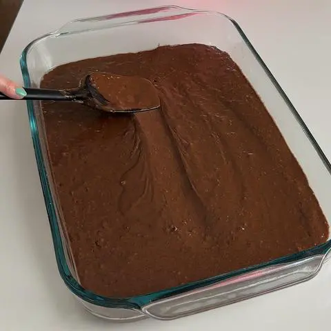 smoothing the top of the batter with a baking spatula.