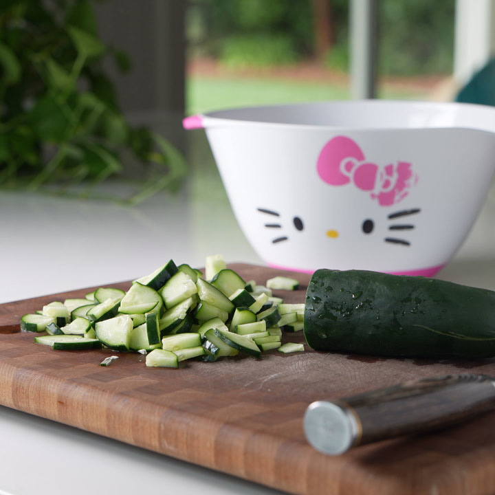 dicing a cucumber on a cutting board