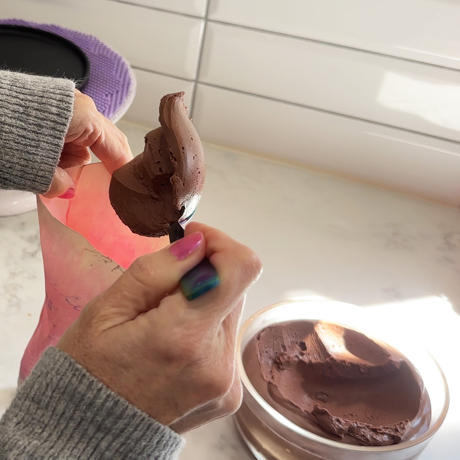 Filling a piping bag with vegan mousse.