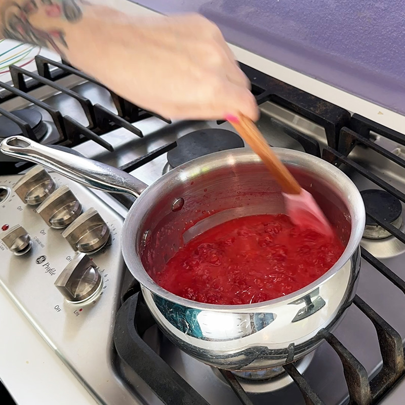 Making the raspberry filling on the stove.