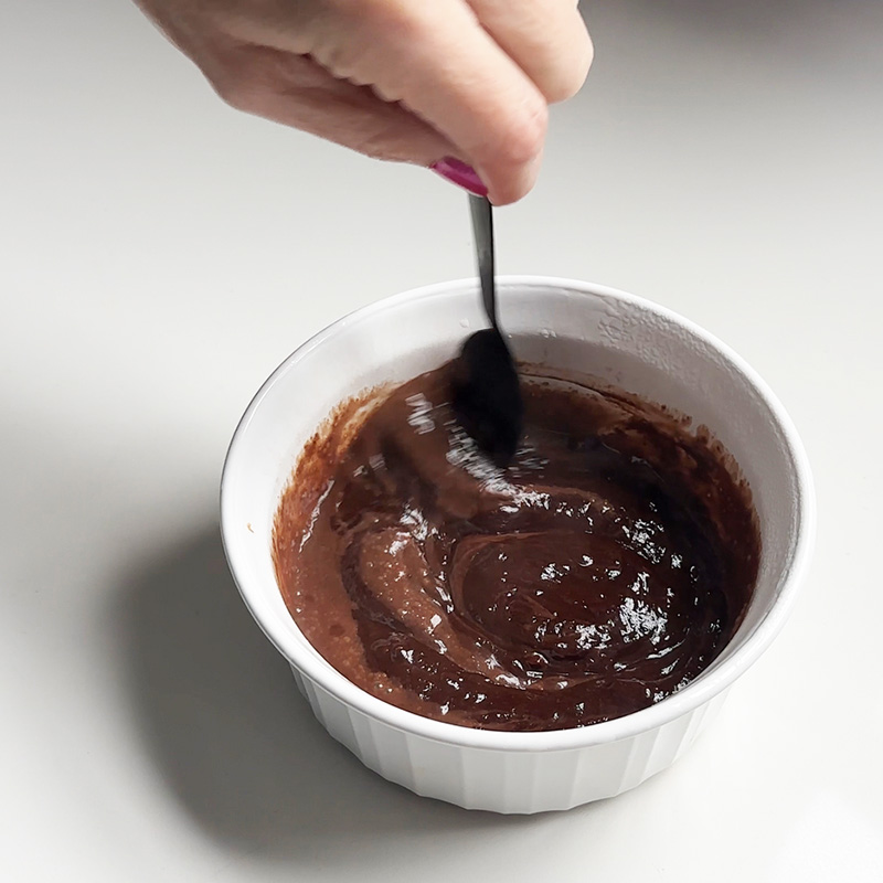 Stirring melted chocolate chips.