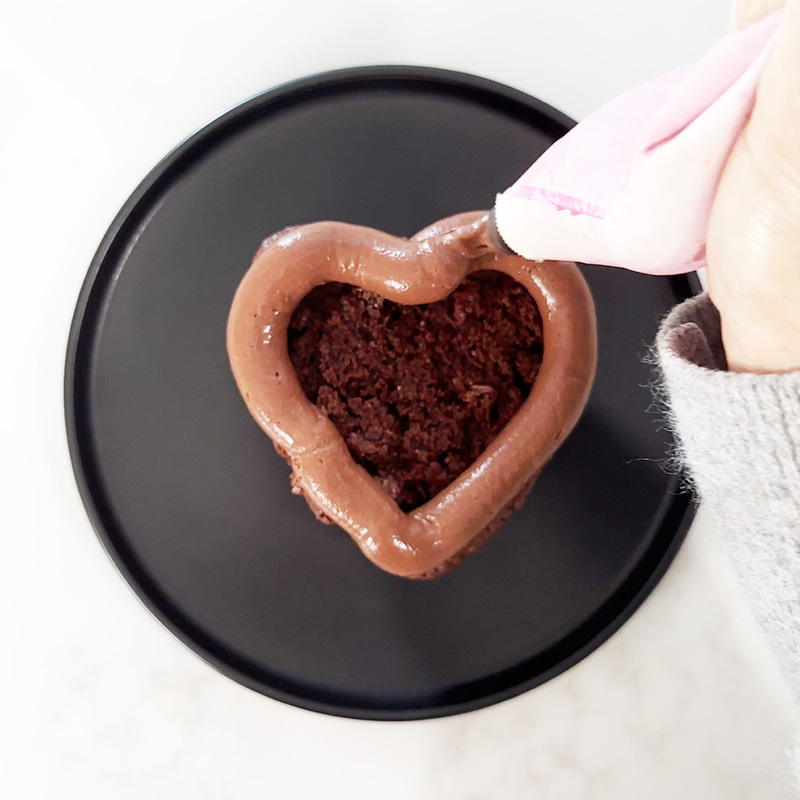 Piping a chocolate hazelnut mousse border.