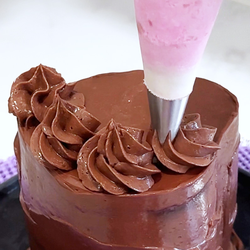 Decorating the mini vegan raspberry nutella cake.