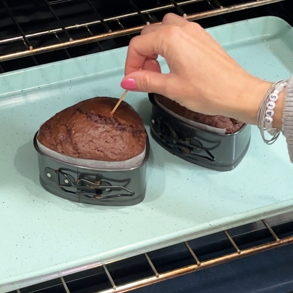 Checking the cakes for doneness.