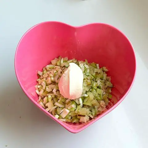 pink heart bowl with vegan tuna, celery, pickle, and vegan mayo.