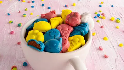 a white bowl with a bunny on it, filled with pb2 peanut butter cups