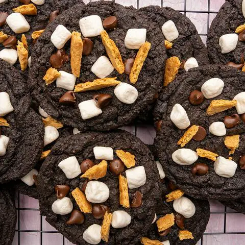 overhead view of the chocolate s’mores cookies stacked on a cooling rack.