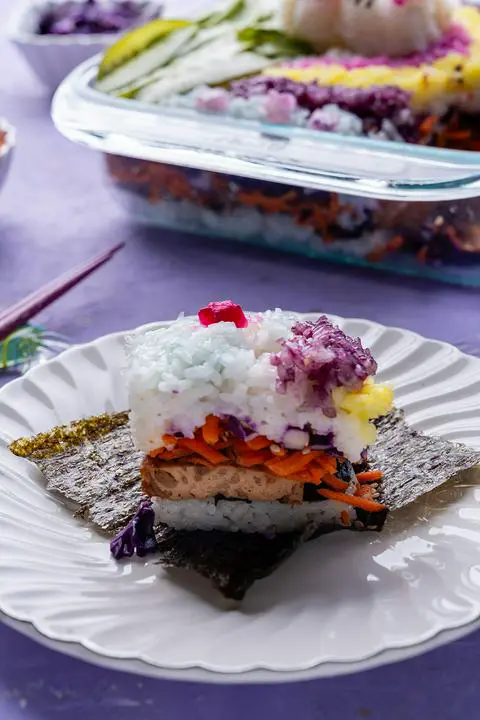 a piece of sushi casserole on a small plate