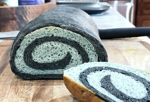 black and blue swirl bread sliced open to see the swirl