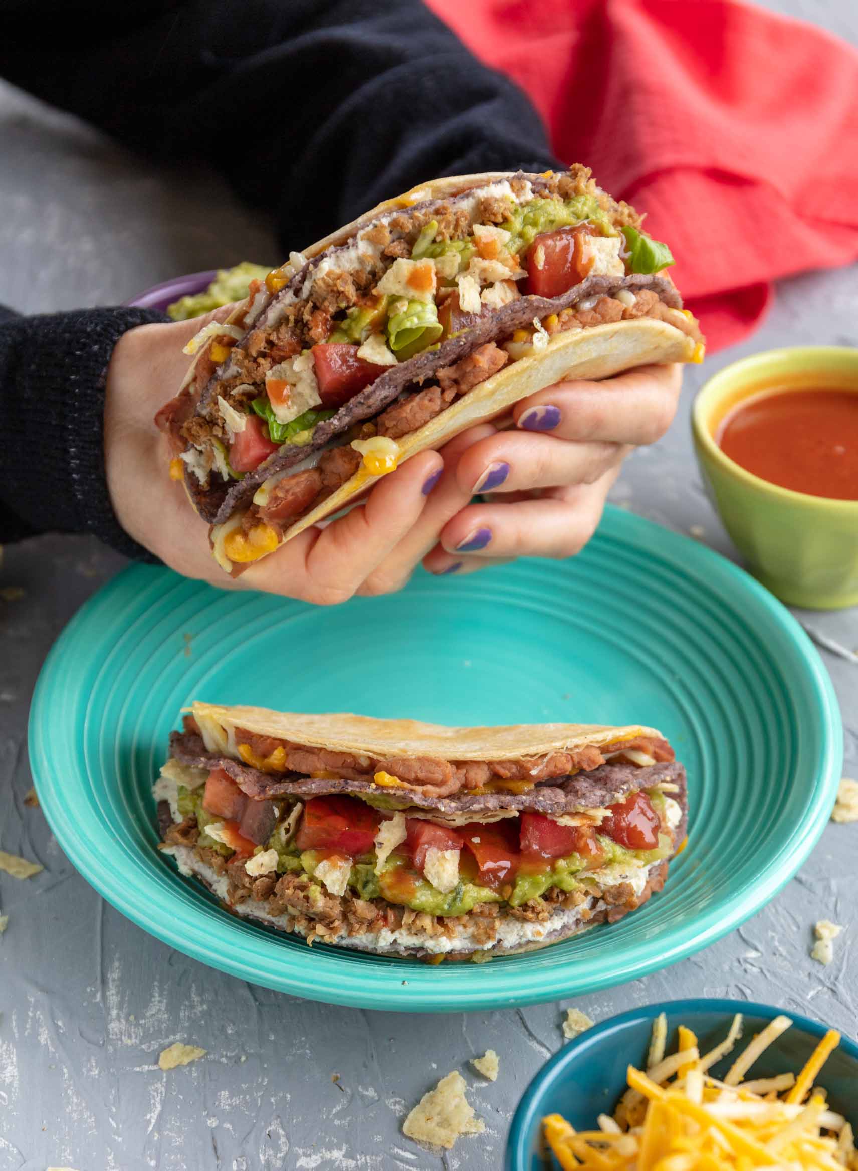 holding a vegan double stuffed taco