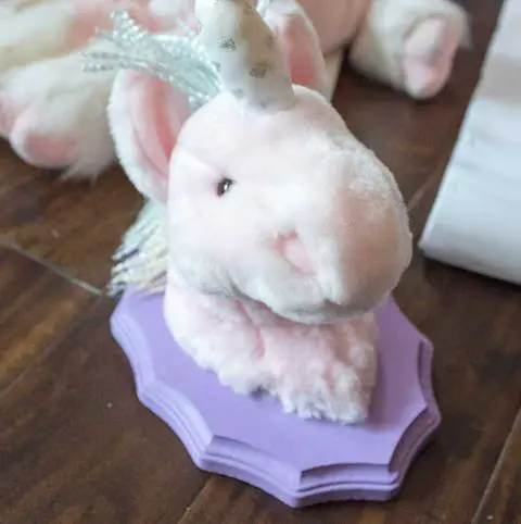 gluing the animal head to the plaque.