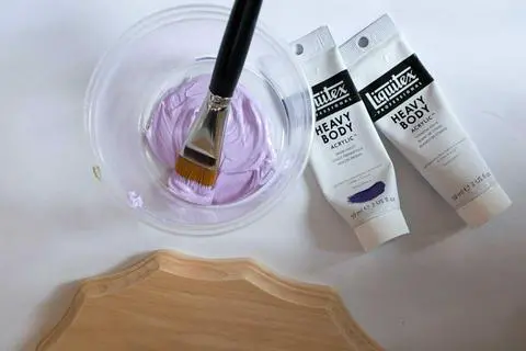 painting the board for your diy stuffed animal trophy.