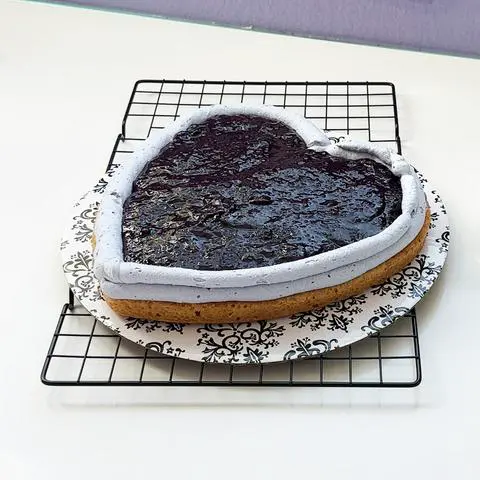 one layer of heart cake with blueberry filling on top.