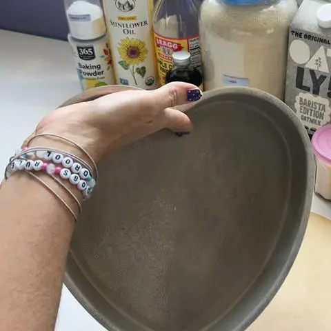 coating the cake pan with oil using my hand.
