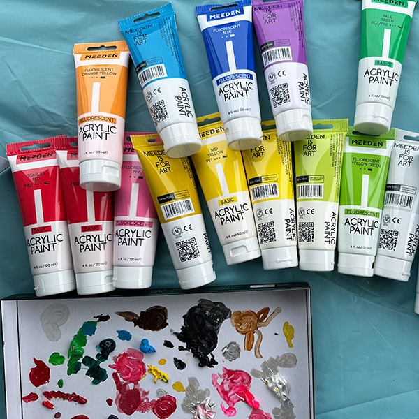 meeden acrylic paints on a table.